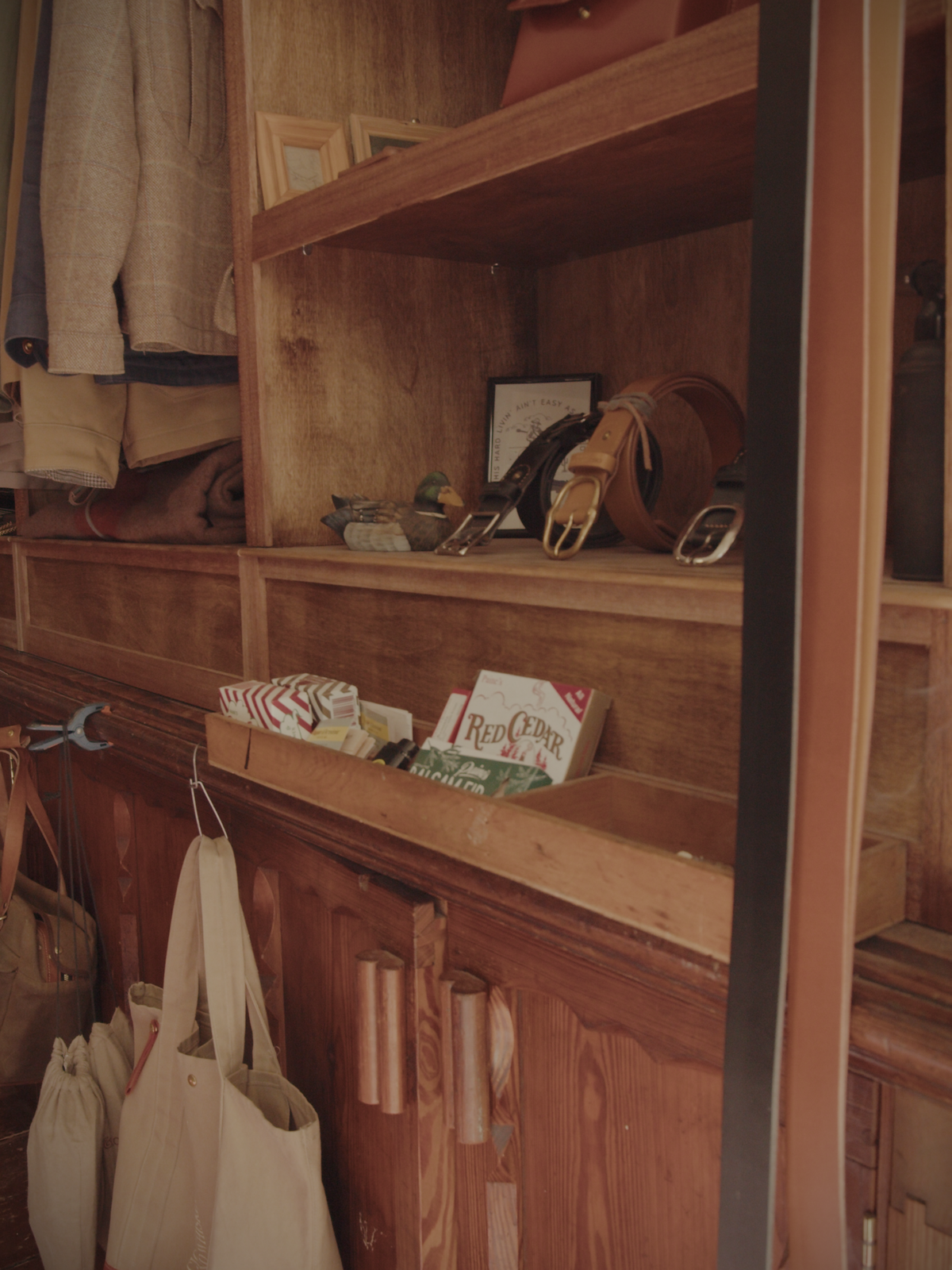 Inside the workshop with belts on display and incense cones burning to scent the space.