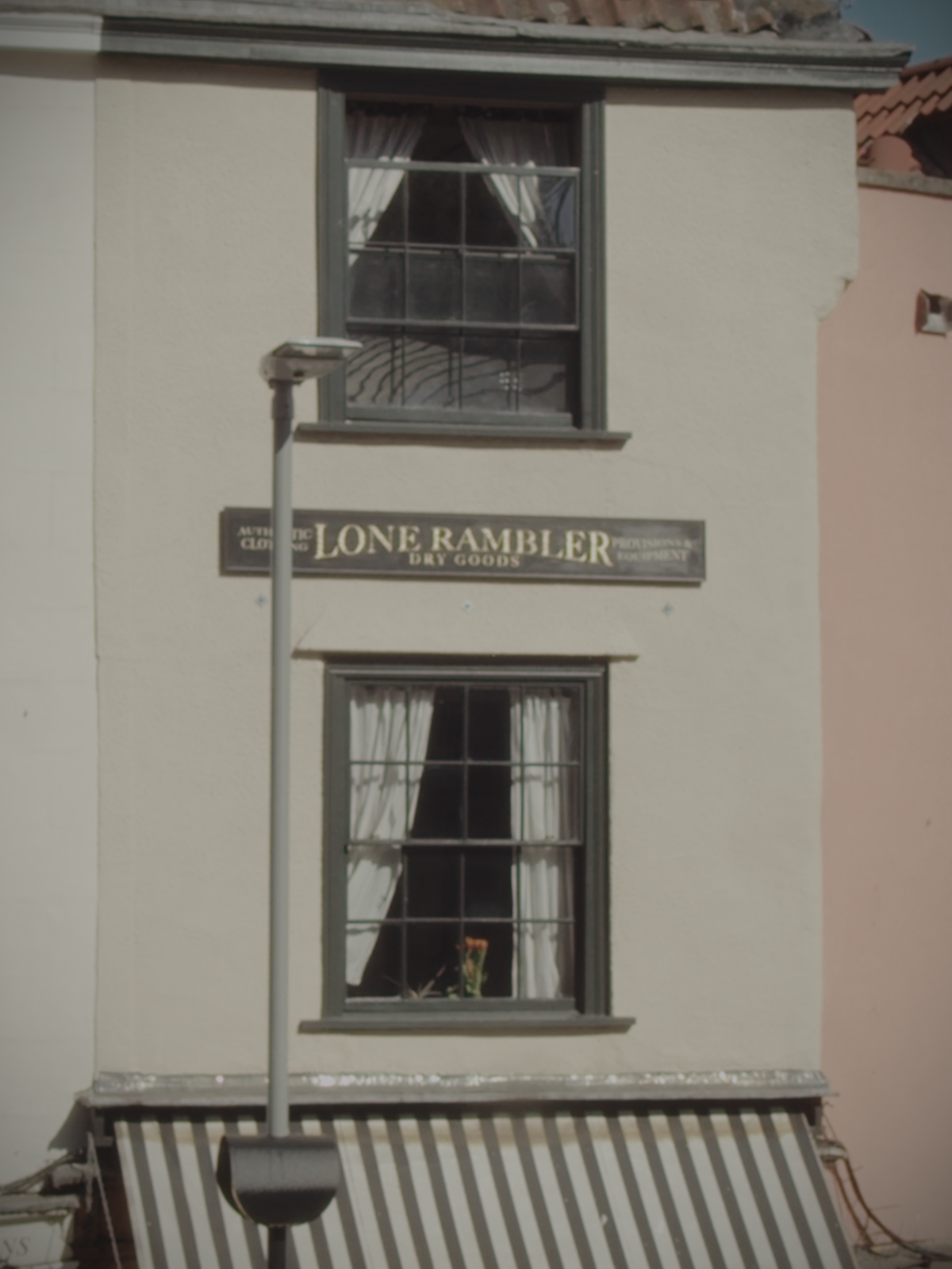 Exterior of Lone Rambler workshop with hand-painted gold “Lone Rambler Dry Goods” sign on building.